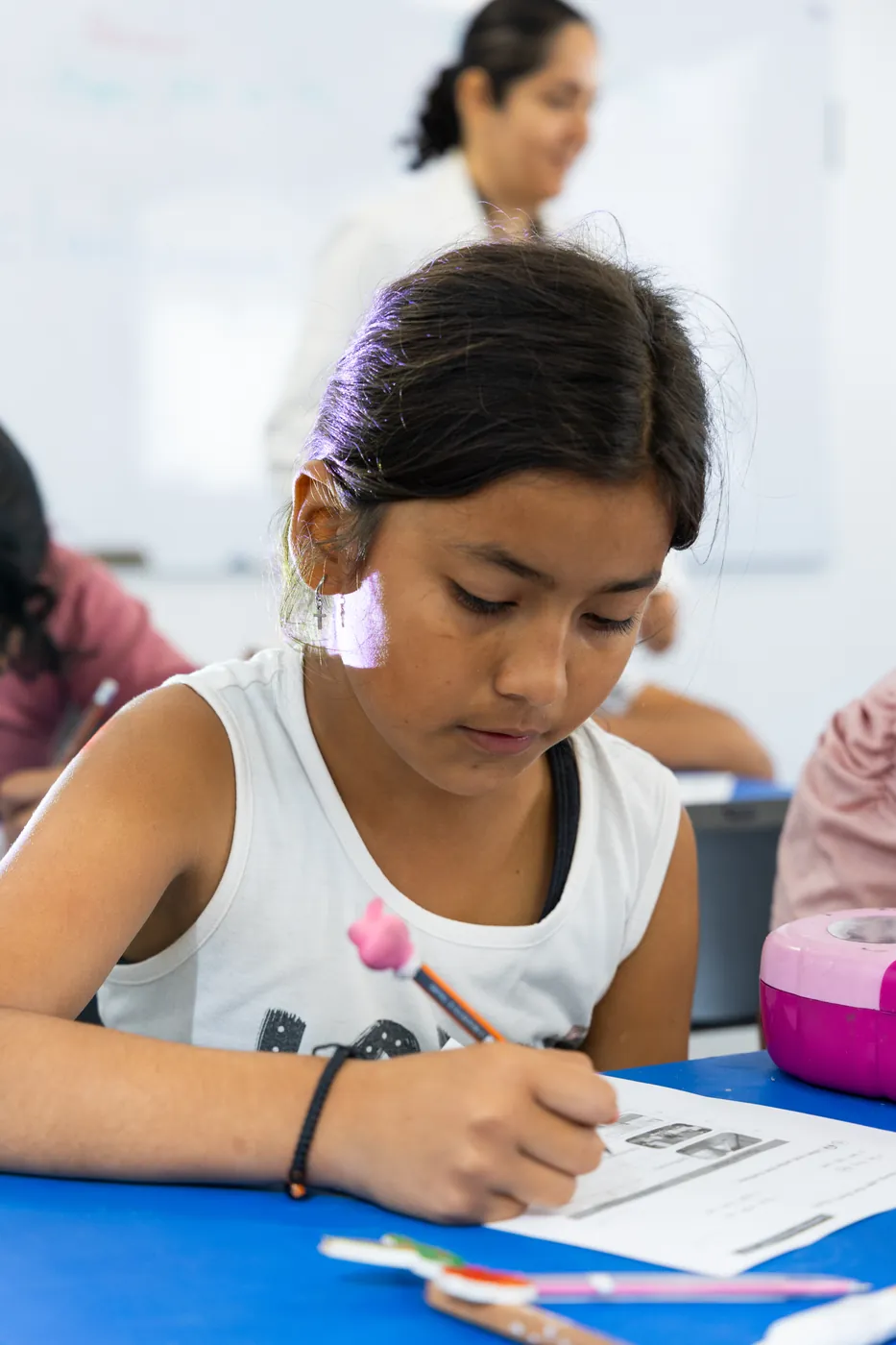Young student writing during class at PEACE Punta de Mita